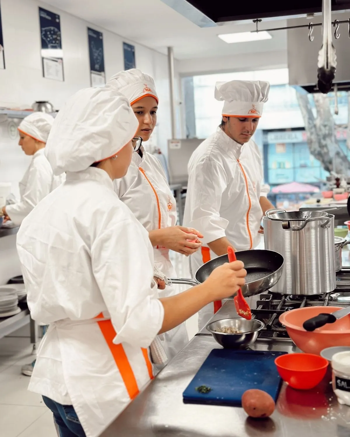 Grupo de alumnos cocinando en las hornallas durante una clase